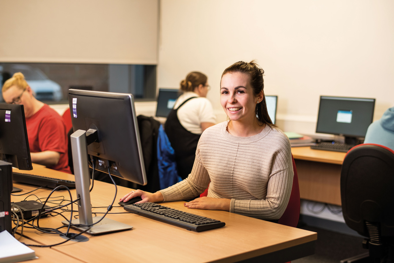 Professional qualification students using laptops in a classroom