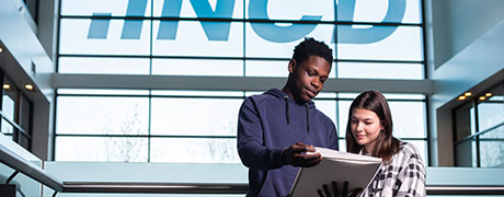 two students looking at a book