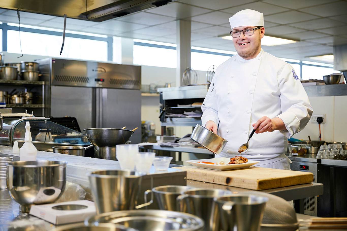 Cookery student at workstation
