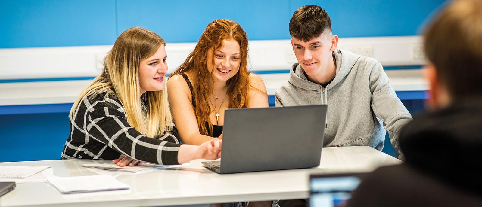 Students working at a laptop