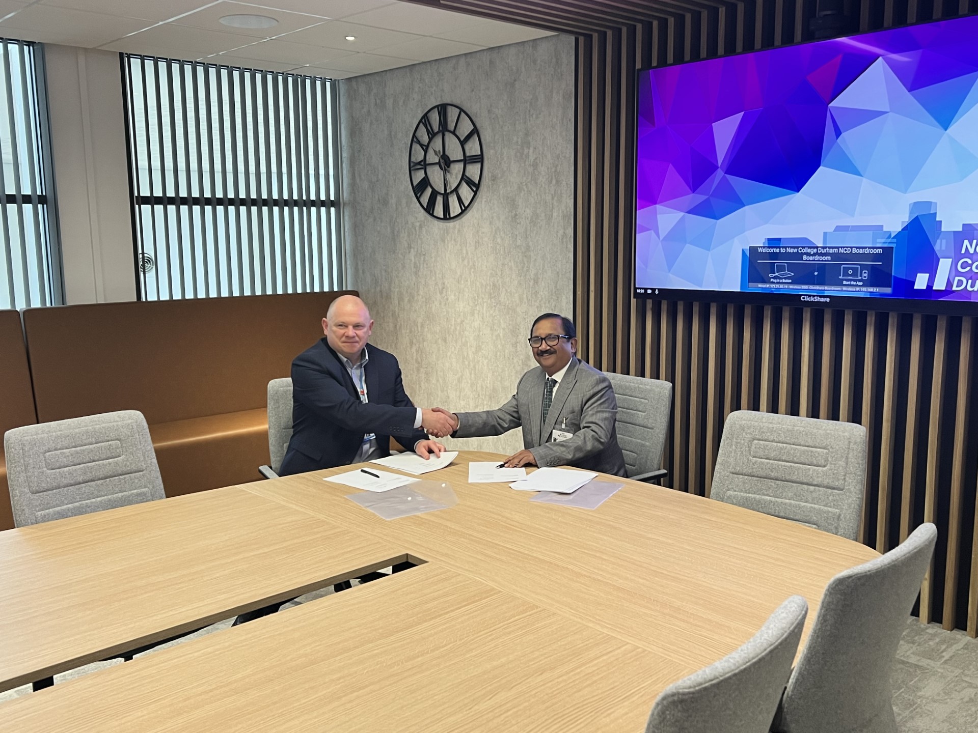 Andy Broadbent, Principal and CEO of New College Durham, and Dr Padmesh Gupta, Managing Director of Oxford Business College, seal the new partnership