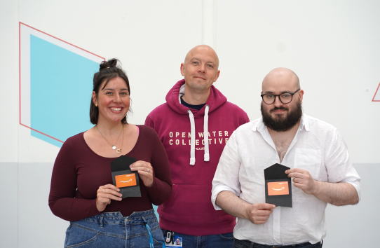 winners posing with their amazon vouchers